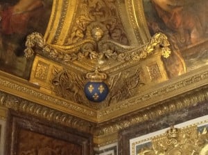 An ornate corner in the ceiling, decorated with the fleur-de-lis, the symbol of French royalty.