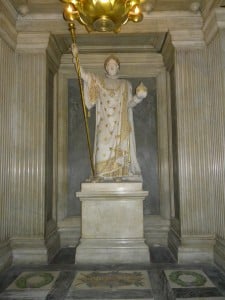 The statue of Napoleon in a chaplet or niche directly opposite (and in a straight line with) the altar and his sarcophagus.