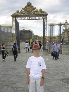 Outside the gold-embellished gate of Versailles . . . 